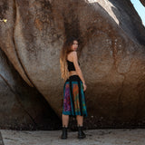 Back view of flowing psy fashion skirt with colourful die-dye panels and teal hem