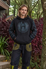 Men’s black fleece-lined hoodie with blue tribal geometric print on the front and sleeves, worn with harem pants