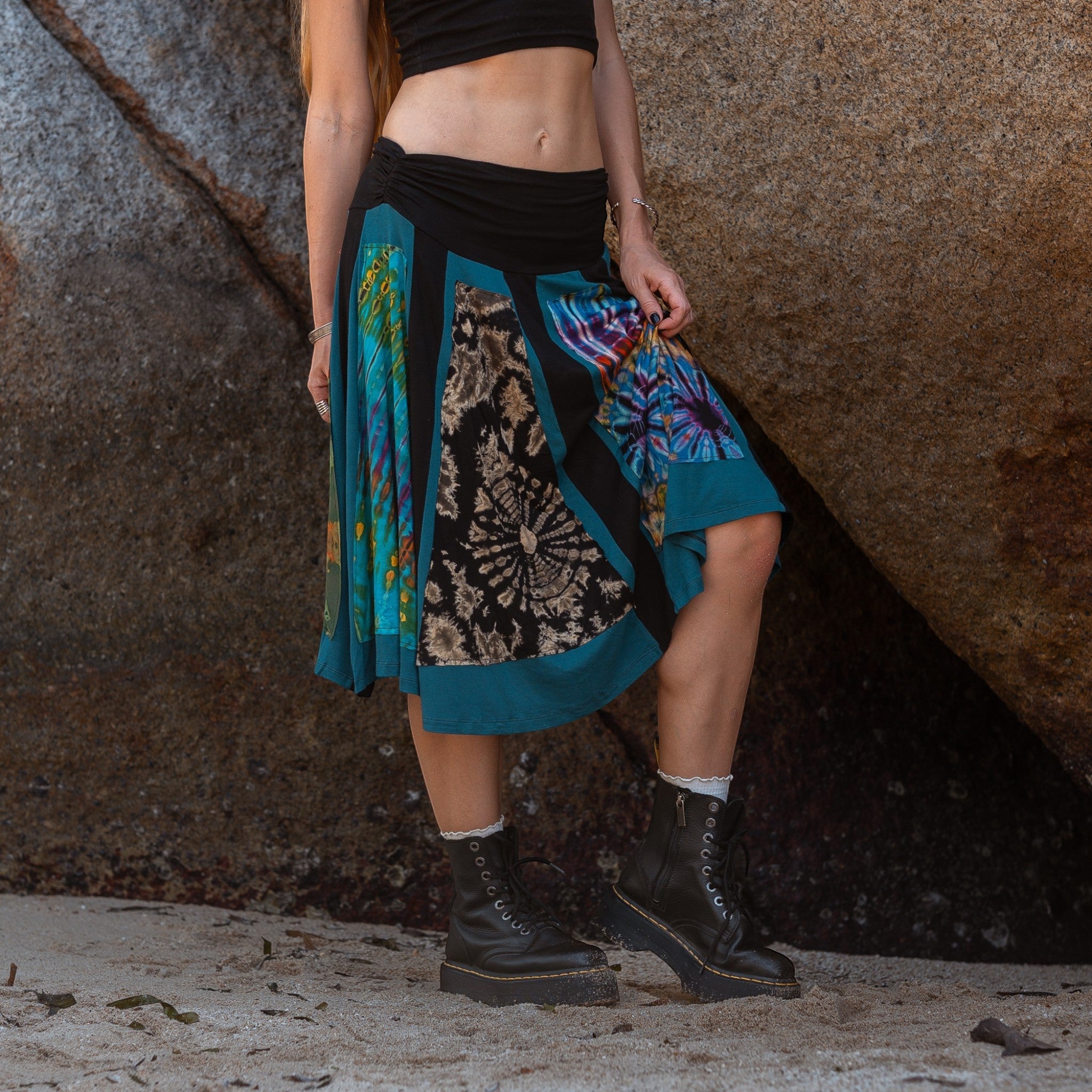 Vibrant hippie skirt featuring multicolour tie dye panels and teal trim, ideal for festivals
