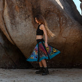 Side view of a swirling tie-dye patchwork sirt in motion showing it's flared shape and comfy waistband