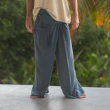 Grey Thai fisherman pants in a hemp and cotton blend, tall prototype fit for men 6'2"+, adjustable wrap waist, ideal for yoga, meditation, travel, and relaxed boho summer style.