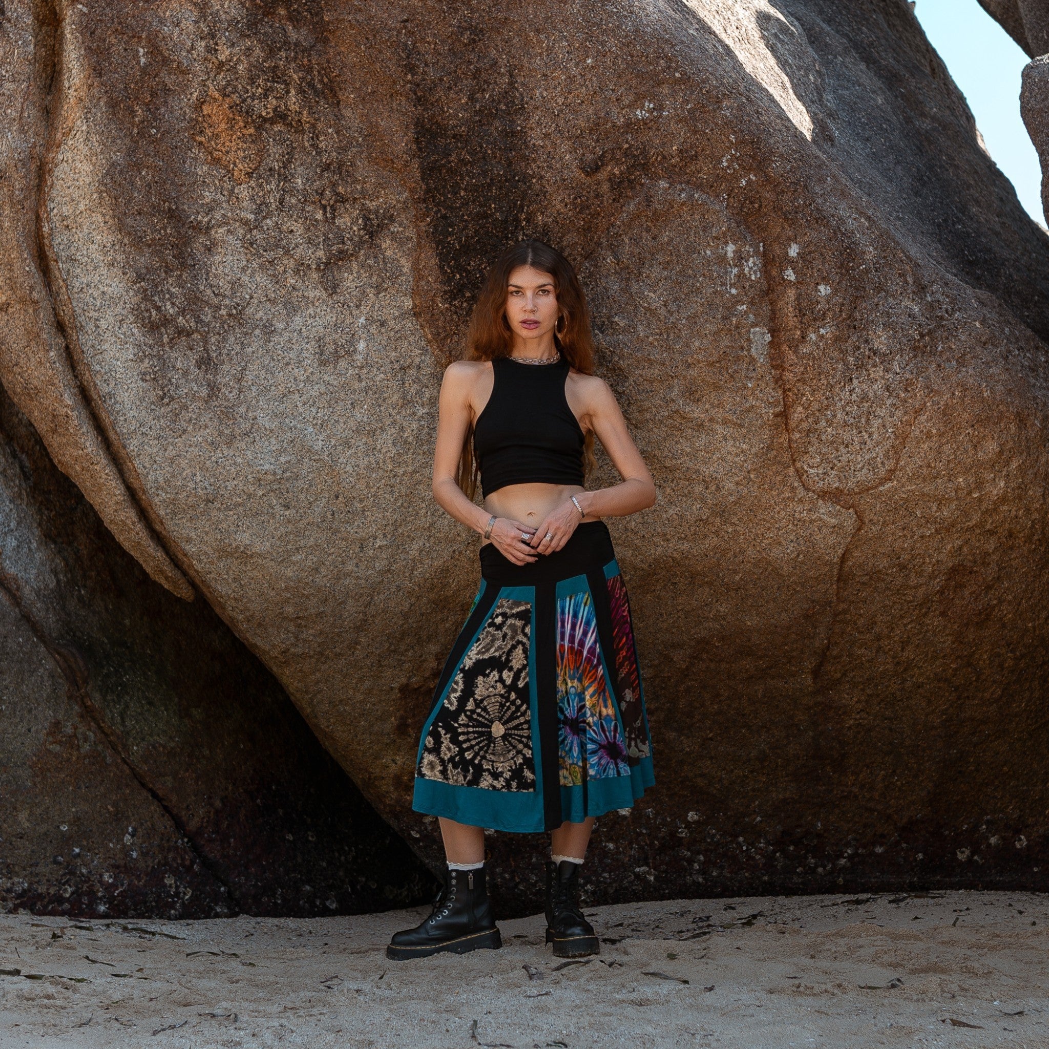Full length view of a woman wearing a boho patchwork skirt with a stretchy ruched black waistband