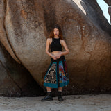 Full length view of a woman wearing a boho patchwork skirt with a stretchy ruched black waistband