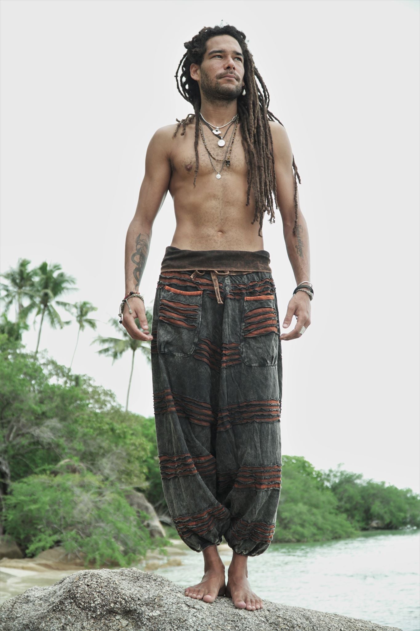 Men's alternative charcoal stonewashed razorcut pants with a rust orange underlayer and relaxed drop crotch silhouette.