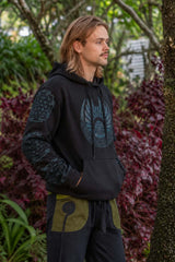 Side view of men’s black fleece-lined tribal hoodie with blue geometric chest and sleeve design