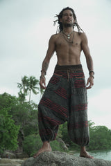 Man modelling charcoal grey stonewashed bohemian harem pants with maroon razorcut detailing, relaxed drop crotch fit and elasticated ankles.