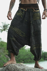 Front detail of men's charcoal stonewashed razorcut harem pants with a green underlayer, showing the waistband, razorcut texture and relaxed fit.