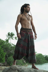 Side view of charcoal grey stonewashed drop crotch harem pants with a maroon razorcut underlayer and handcrafted layered detailing.