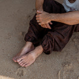 Elasticated ankle cuff detail on men's brown stonewashed harem pants, festival trousers