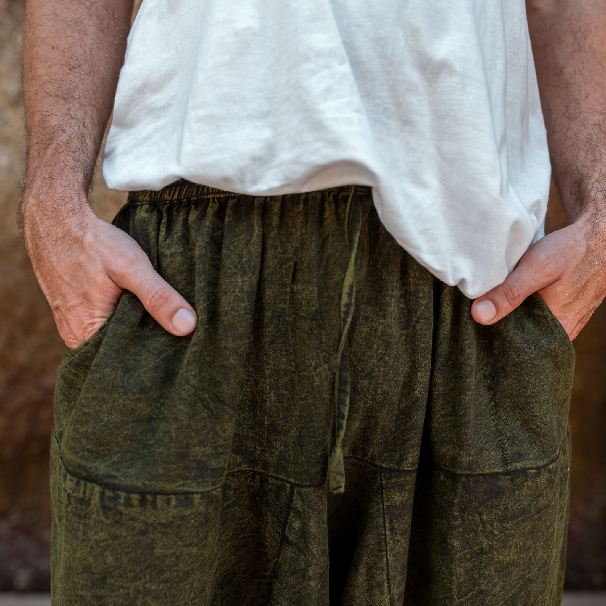 Front pocket detail on men's khaki green stonewashed harem pants, boho festival trousers