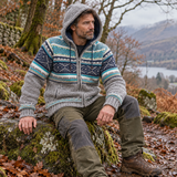Man wearing a brown fleece lined wool jacket with hood, navy and sea green knitted detailing