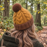 Back view of a mustard and brown chunky cable knit wool hat with pom pom, made from 100% New Zealand wool for autumn and winter