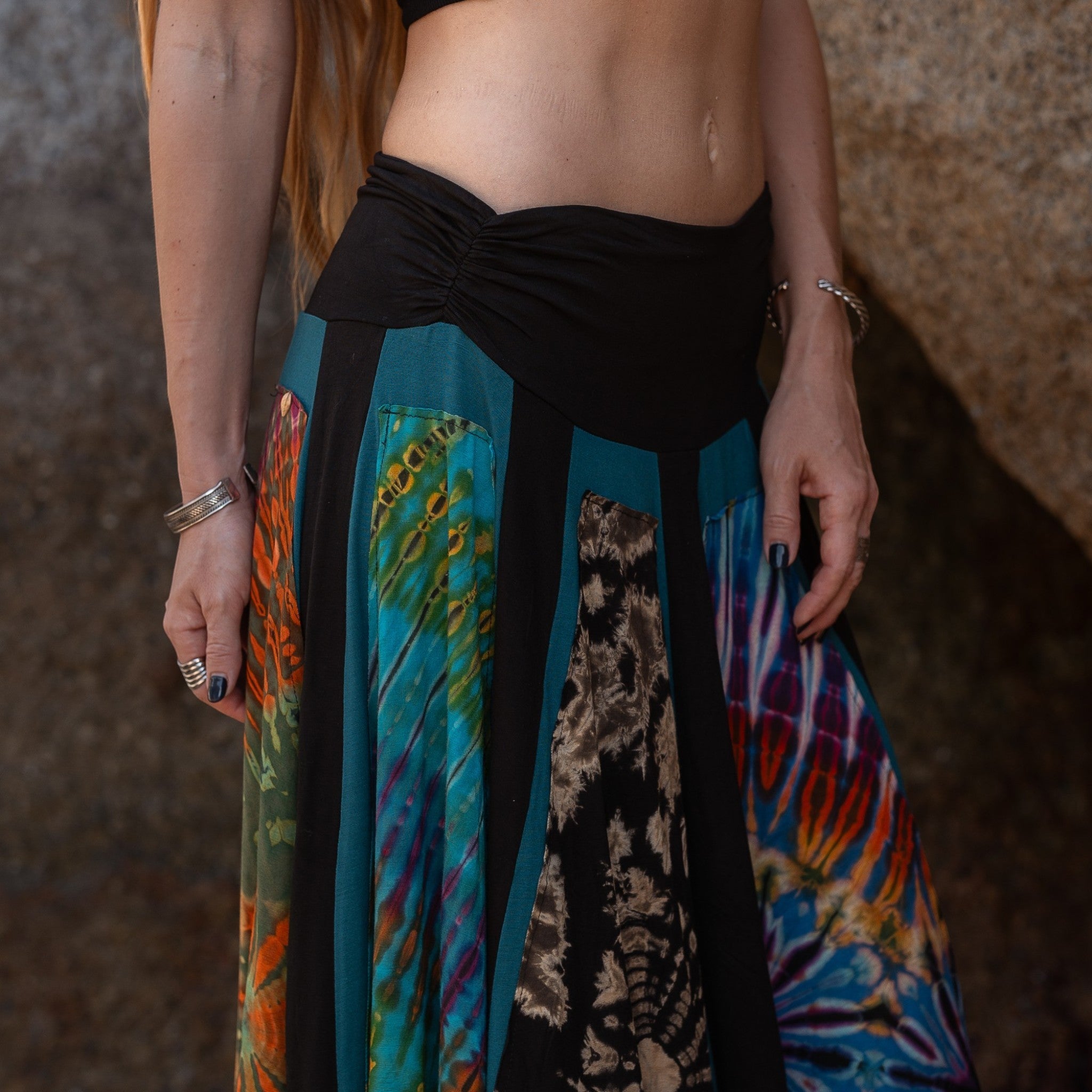 Close-up of colourful psychedelic tie-dye and batik-style fabric on a handmade hippie skirt