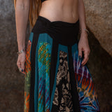 Close-up of colourful psychedelic tie-dye and batik-style fabric on a handmade hippie skirt