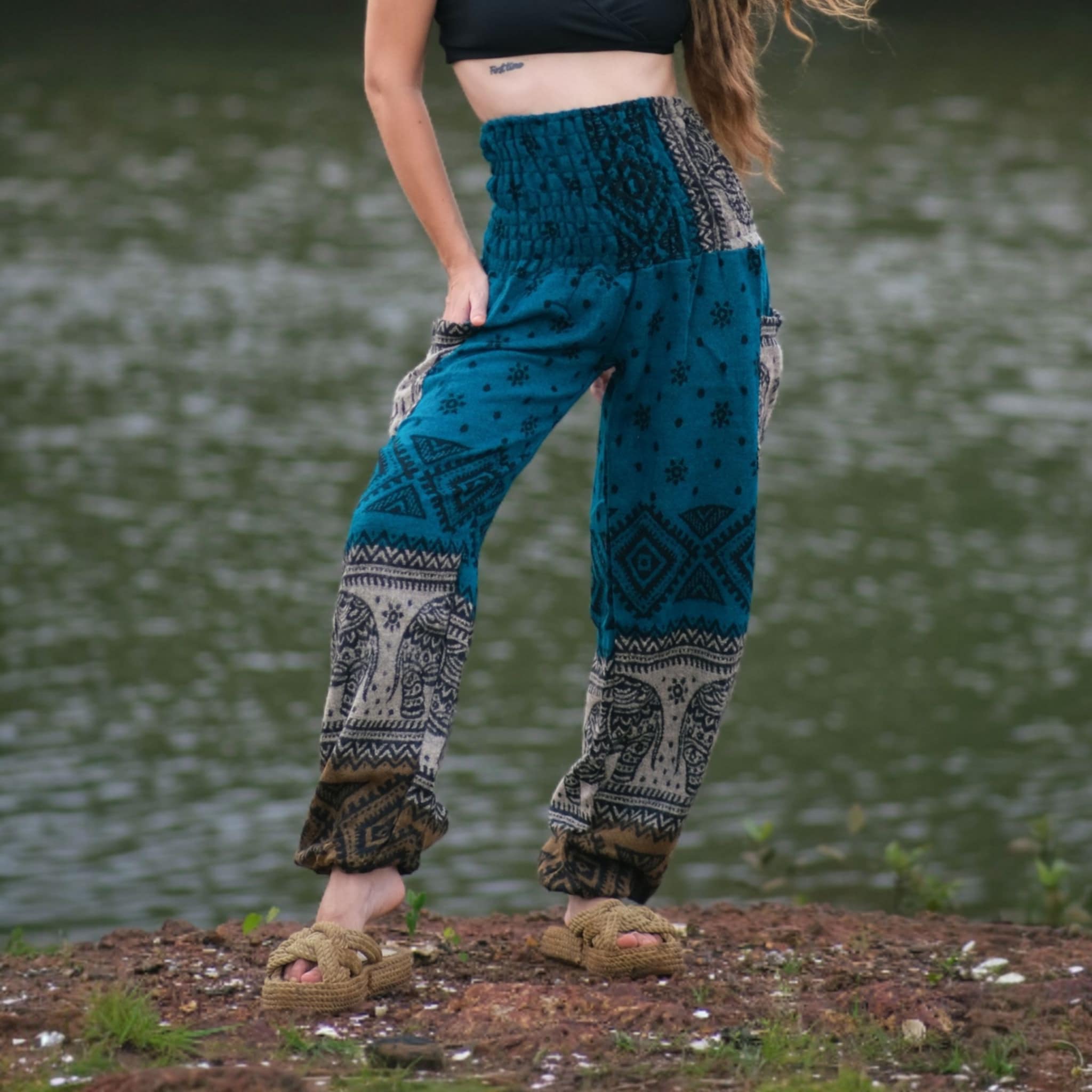 Turquoise teal elephant print warm harem blanket pants with smocked waistband and side pockets, soft cashmilon fleece-style trousers for yoga, lounging, festivals and boho fashion
