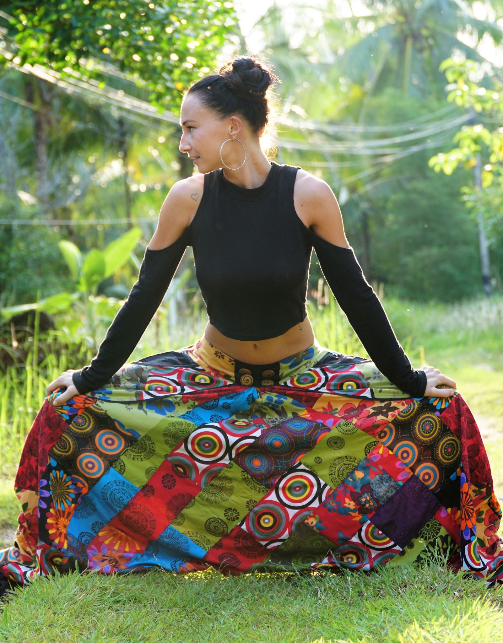 Women's multicolour bohemian patchwork harem pants in festival style, full length front view with wide flared legs and button waist detail