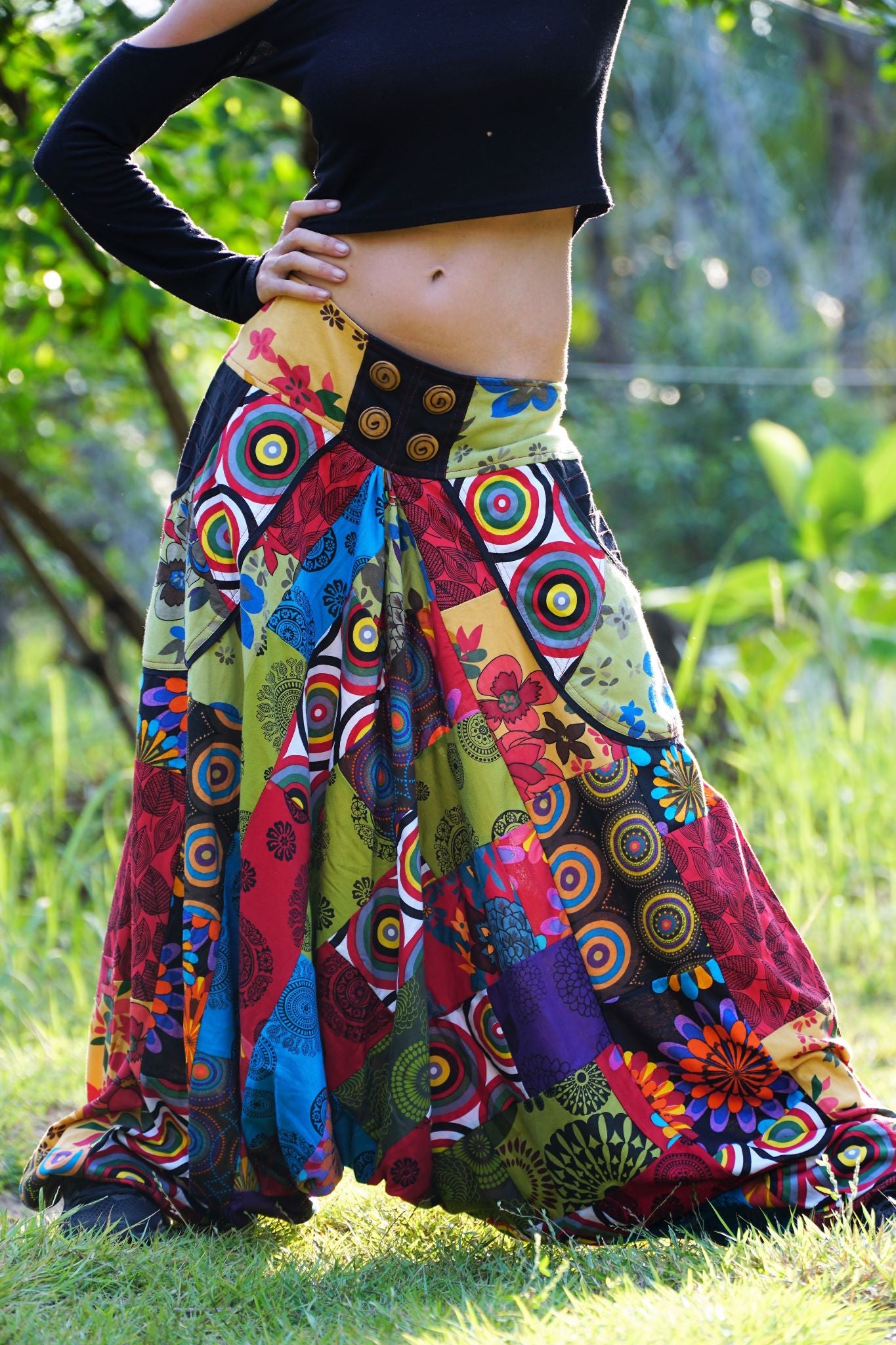 Close-up of drop crotch detail on women's bohemian patchwork harem pants showing vibrant multicolour mandala and floral fabric panels