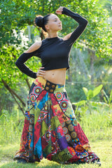 Women's bohemian patchwork harem pants full length view, model in elegant hand-on-hip pose showing mandala and floral prints