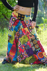 Close-up of women's patchwork harem pants waistband featuring decorative wooden spiral buttons and colourful mandala print panels